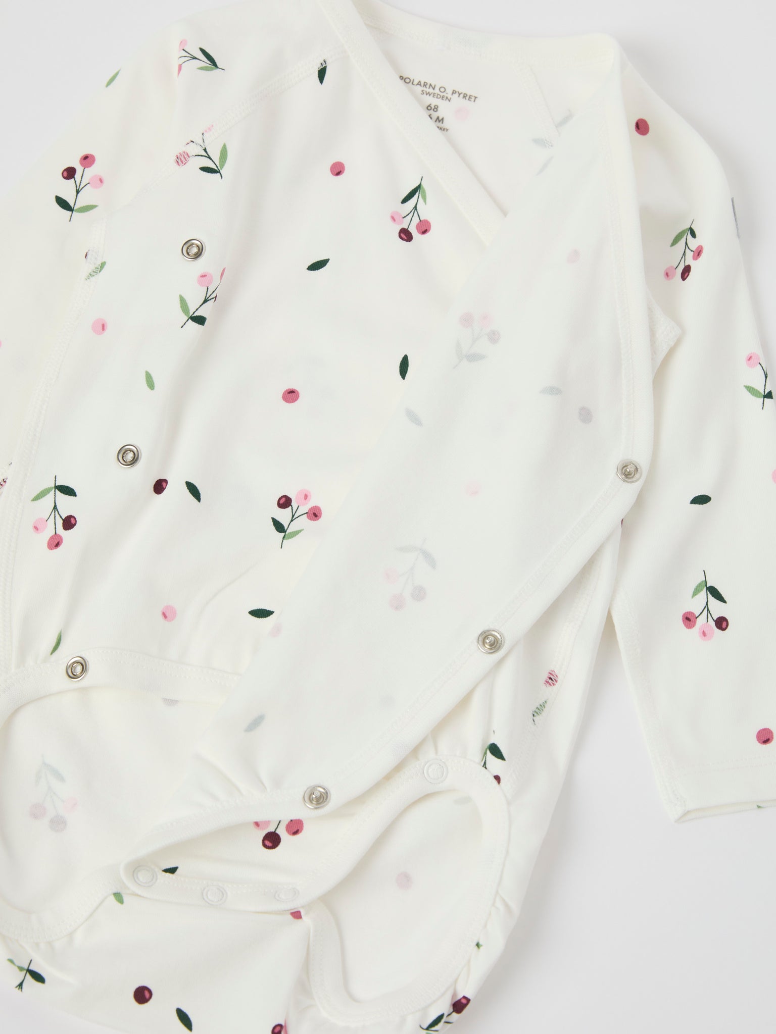 Floral Print Wraparound Babygrow from the Polarn O. Pyret baby collection. Clothes made using sustainably sourced materials.