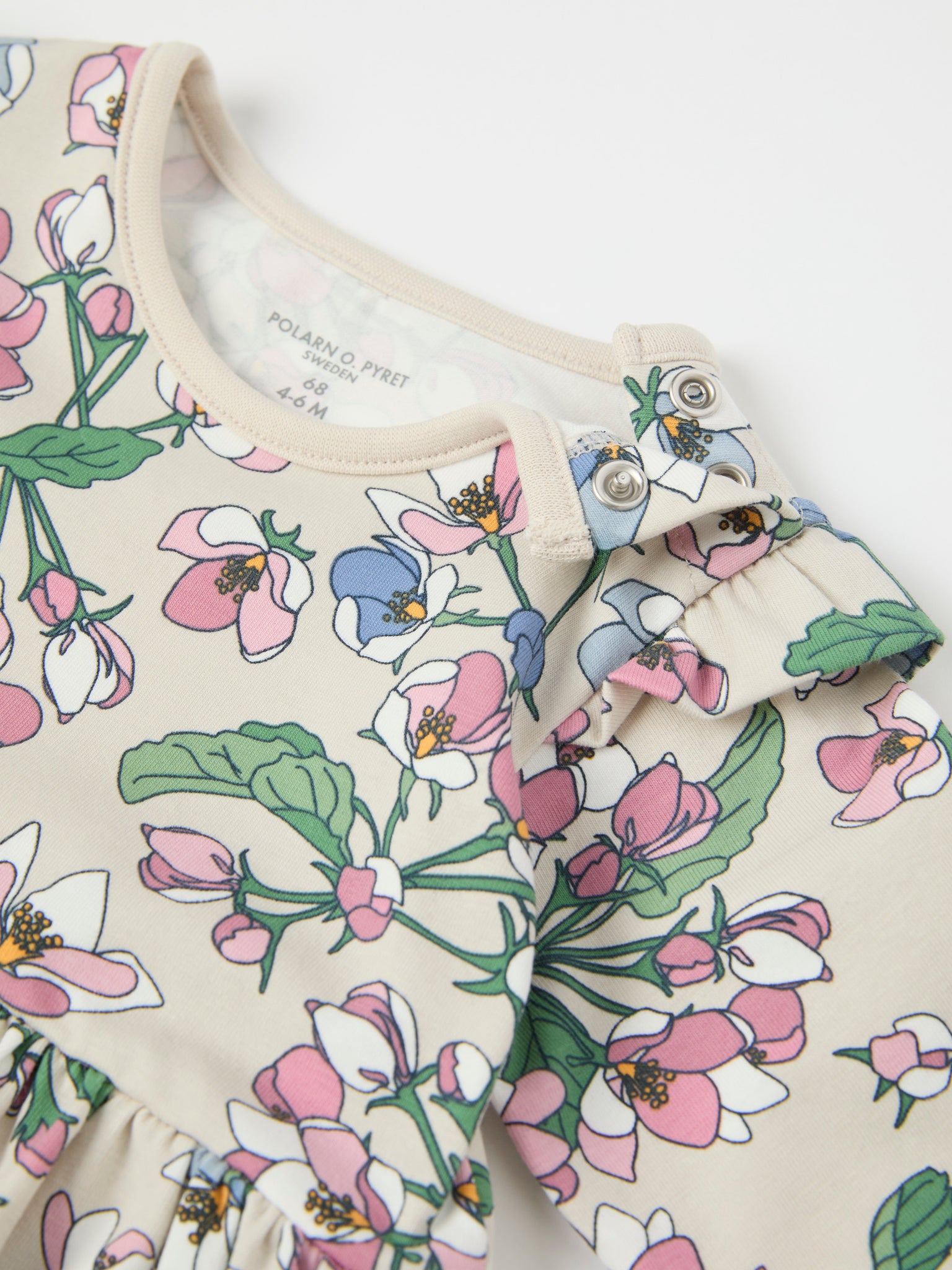 Apple Blossom Print Babygrow from the Polarn O. Pyret baby collection. Clothes made using sustainably sourced materials.