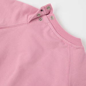 Pink Cotton Baby Sweatshirt from the Polarn O. Pyret baby collection. Nordic kids clothes made from sustainable sources.