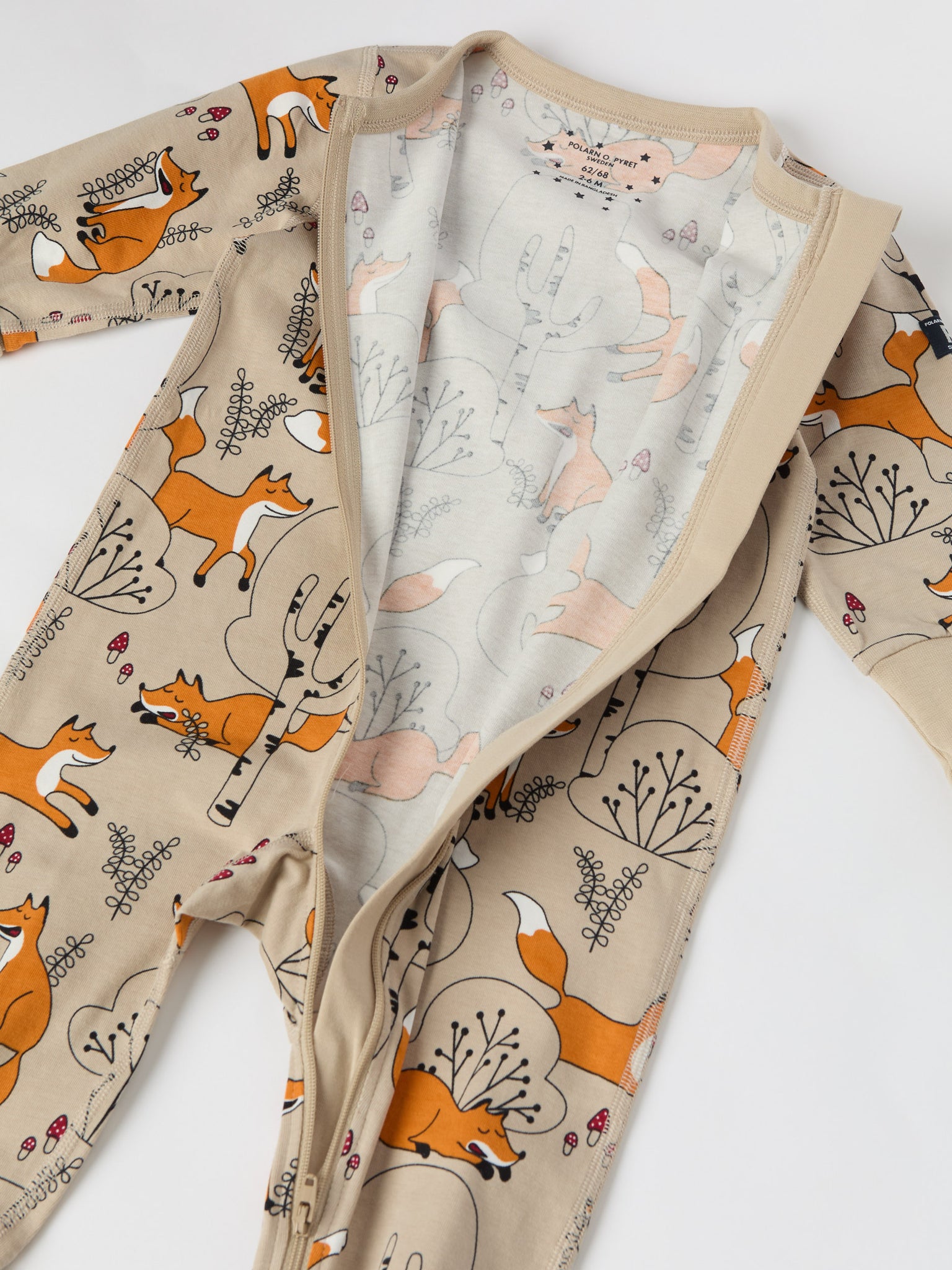 Fox Print Organic Cotton Baby Sleepsuit from the Polarn O. Pyret baby collection. Clothes made using sustainably sourced materials.