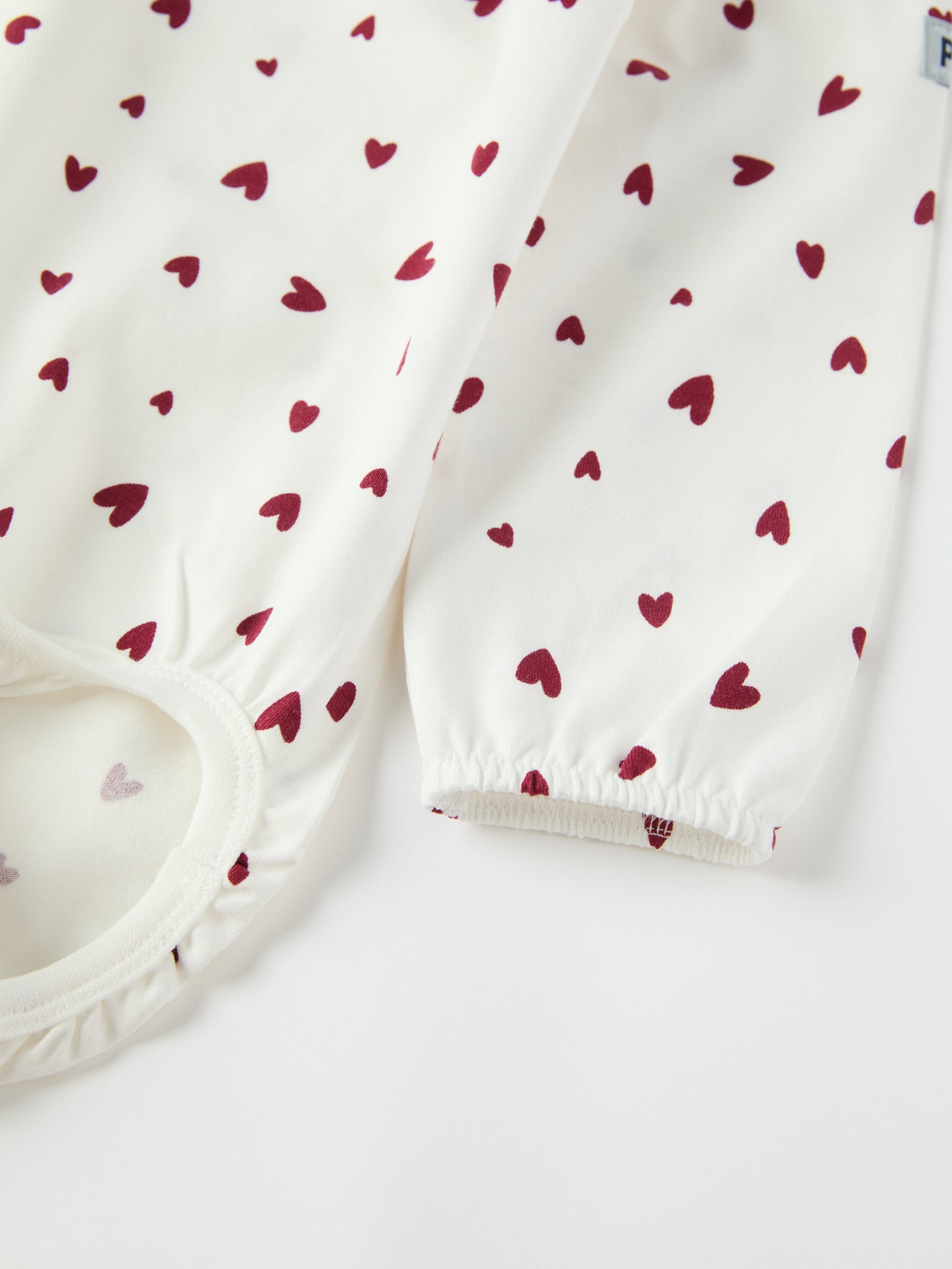 Organic Cotton Heart Print Babygrow from the Polarn O. Pyret baby collection. Ethically produced kids clothing.