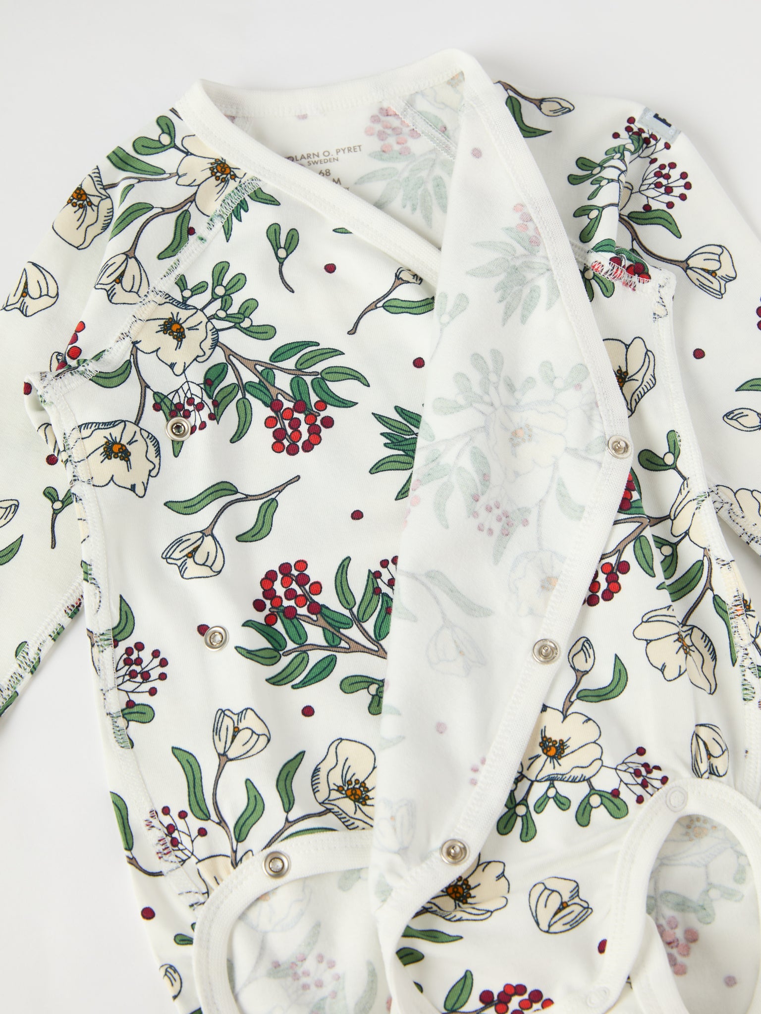 Floral Print Wraparound Babygrow from the Polarn O. Pyret baby collection. Clothes made using sustainably sourced materials.