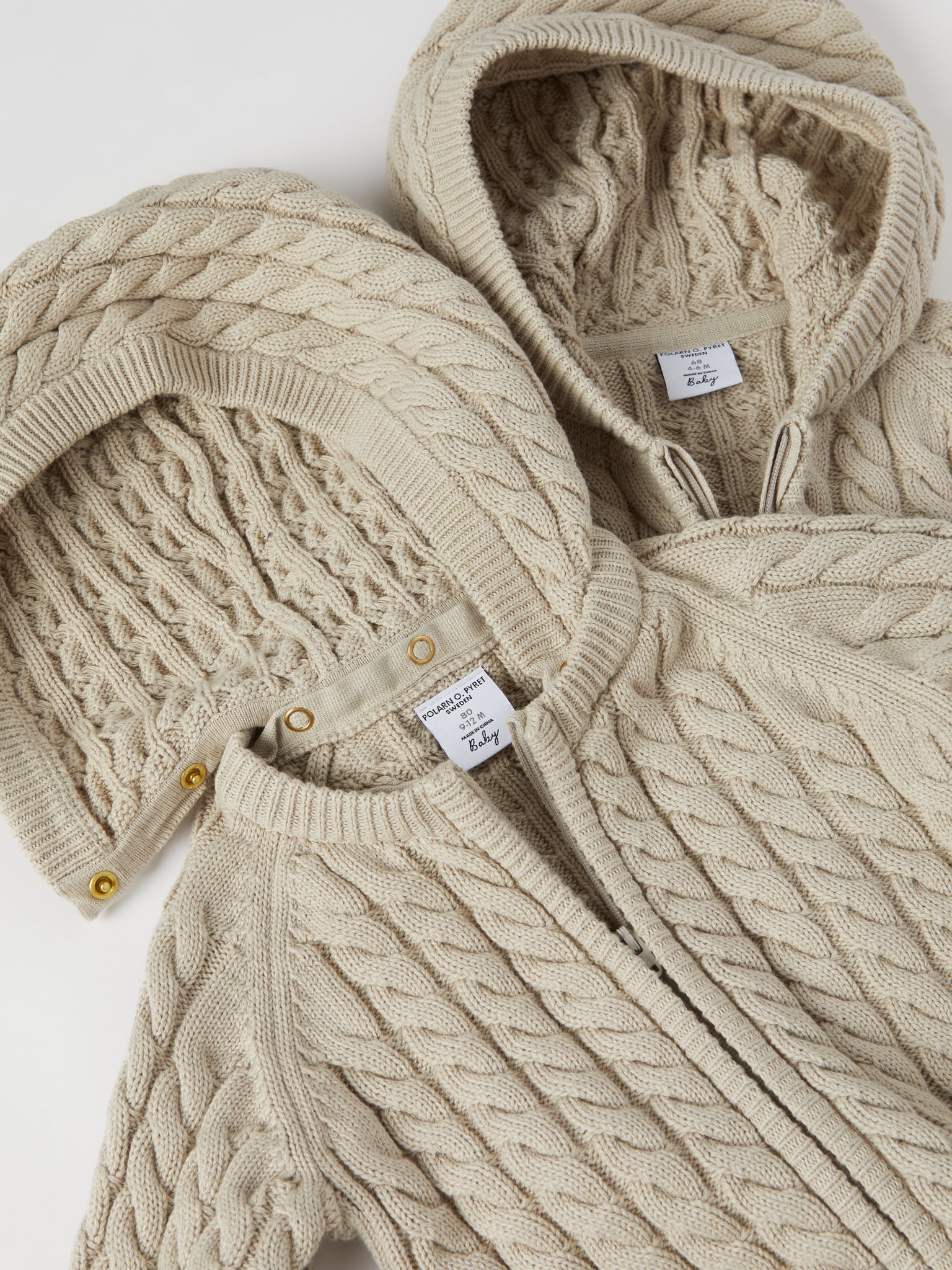 Cable Knit Baby Hooded All-in-one from the Polarn O. Pyret baby collection. Nordic kids clothes made from sustainable sources.