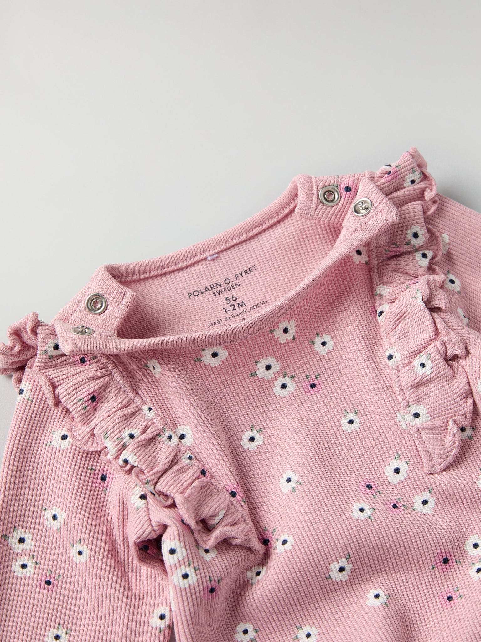 Floral Frilled Babygrow from the Polarn O. Pyret baby collection. Clothes made using sustainably sourced materials.