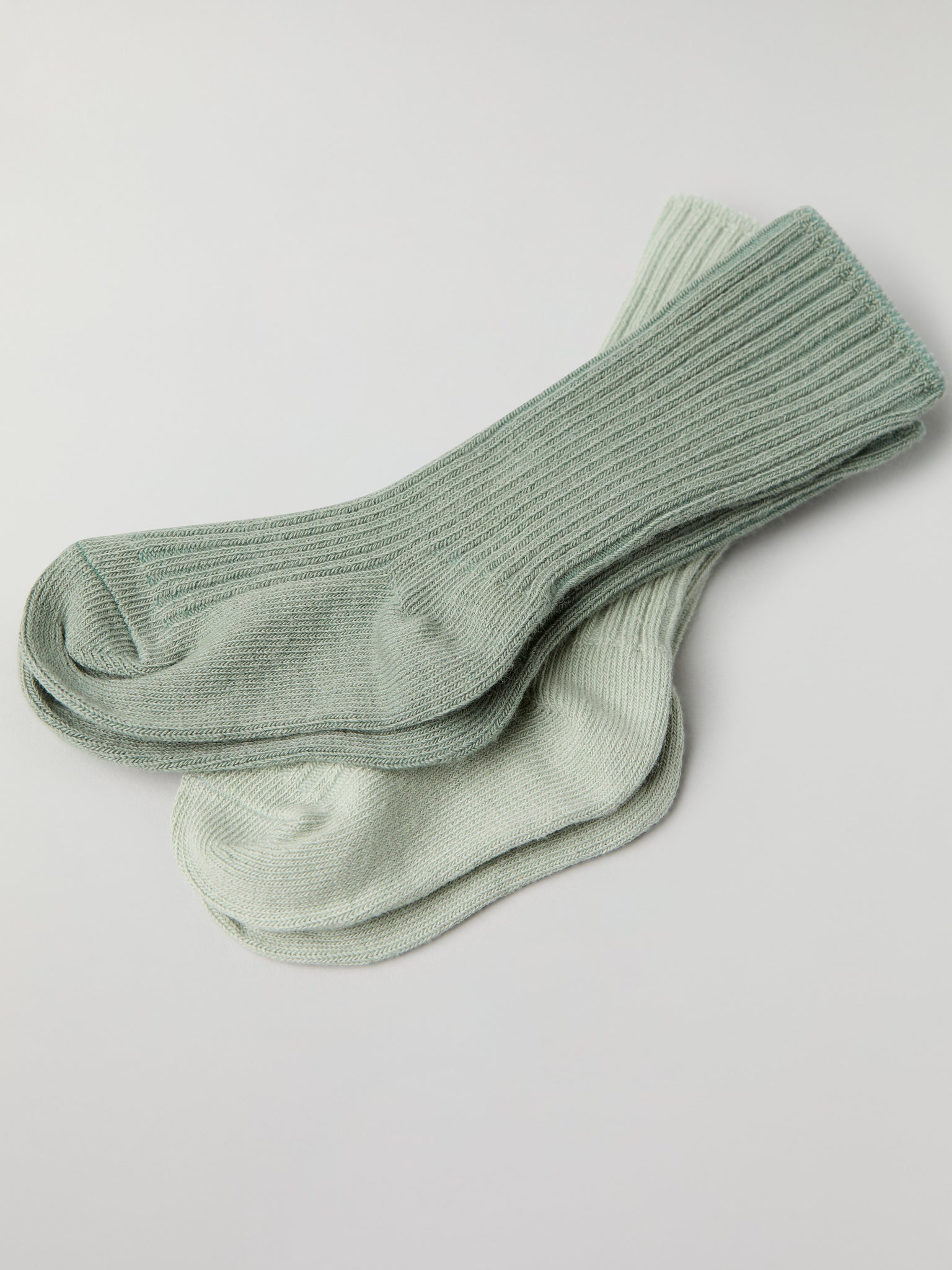 Two Pack Baby Socks in green from the Polarn O. Pyret baby collection. Clothes made using sustainably sourced materials.