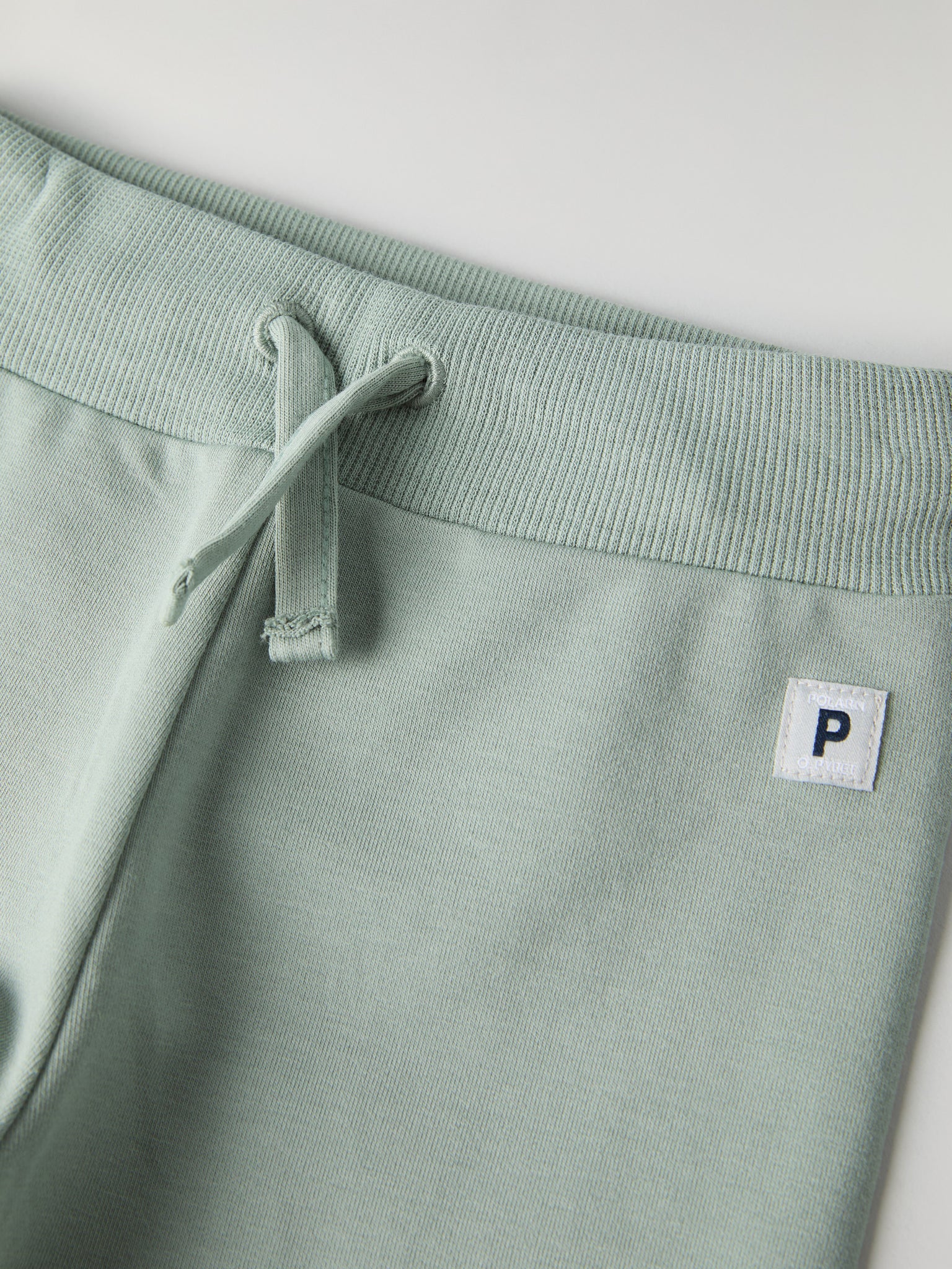 Soft Green Baby Joggers from the Polarn O. Pyret baby collection. Nordic kids clothes made from sustainable sources.