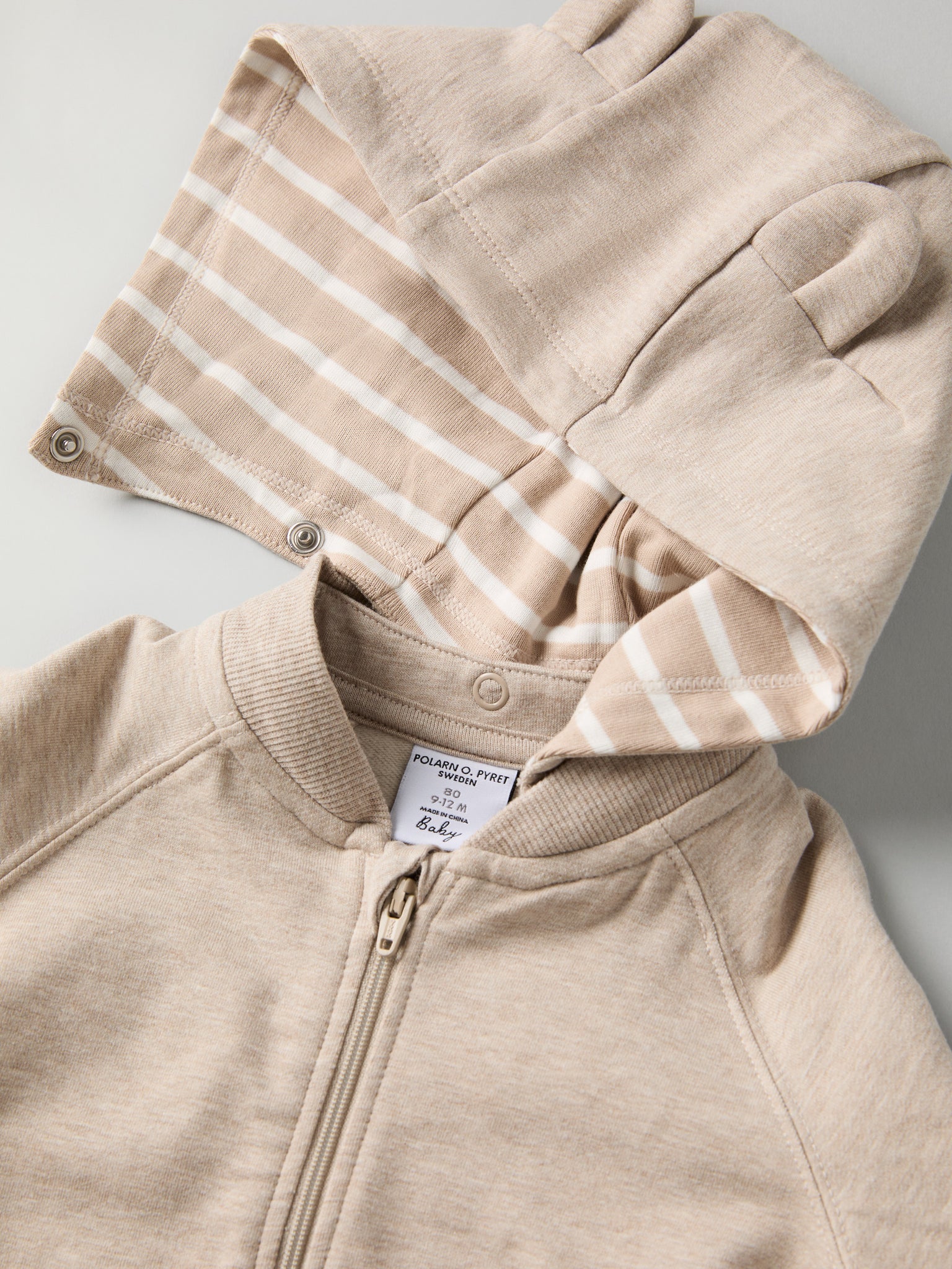 Beige Baby Hoodie from the Polarn O. Pyret baby collection. Nordic kids clothes made from sustainable sources.