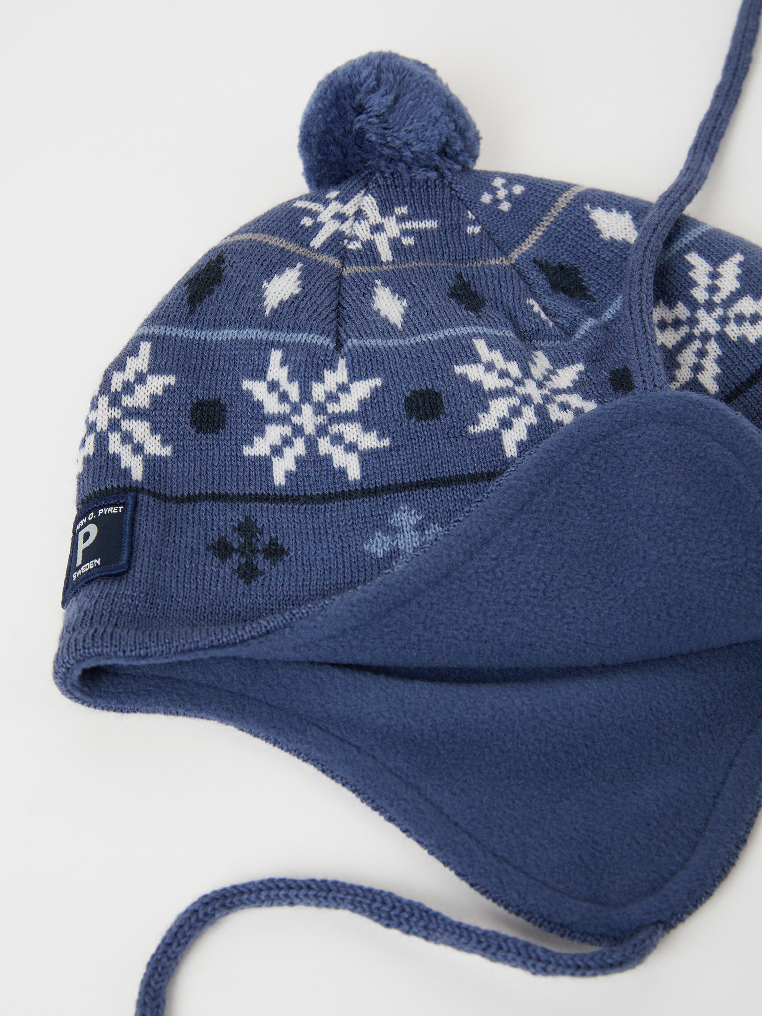 Merino Wool Blue Kids Bobble Hat from the Polarn O. Pyret outerwear collection. Kids outerwear made from sustainably source materials